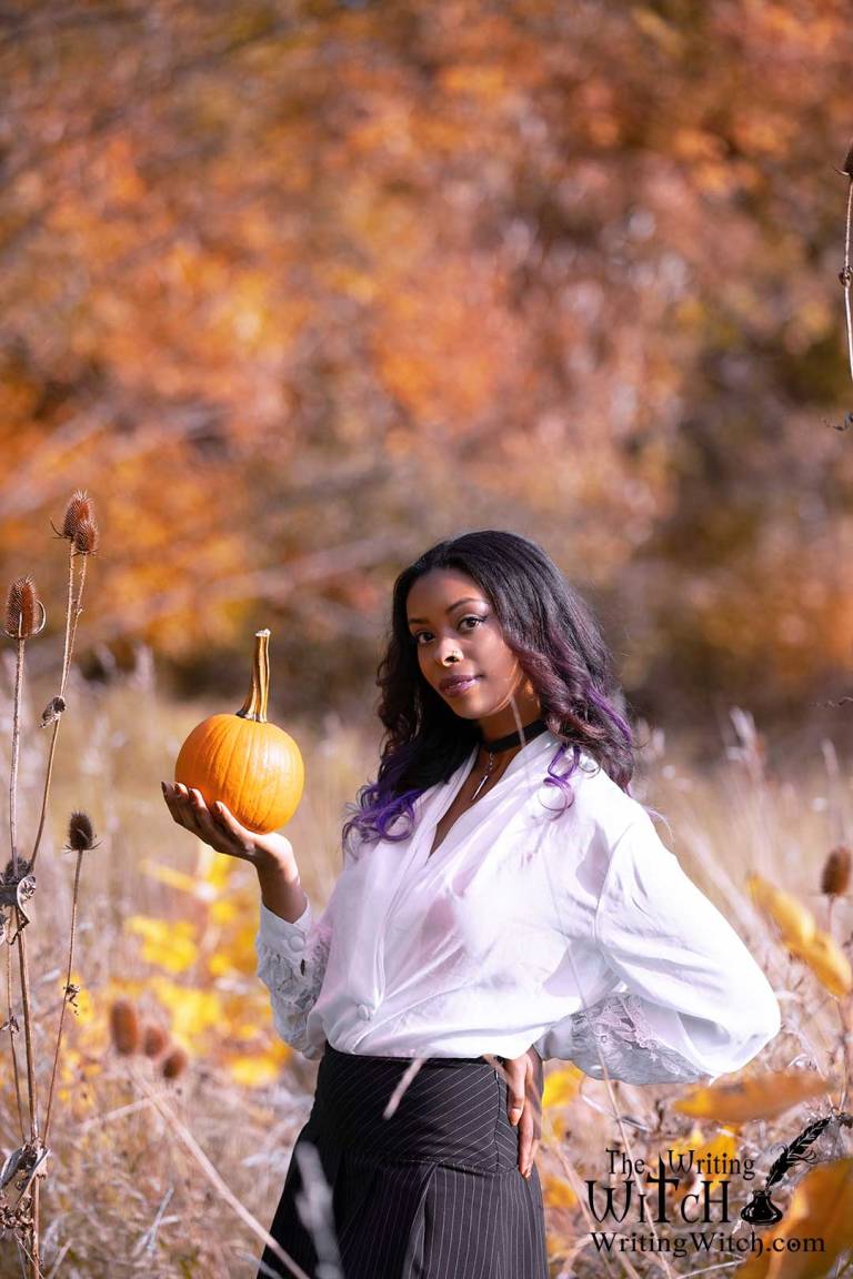 woman-in-autumn field with pumpkin