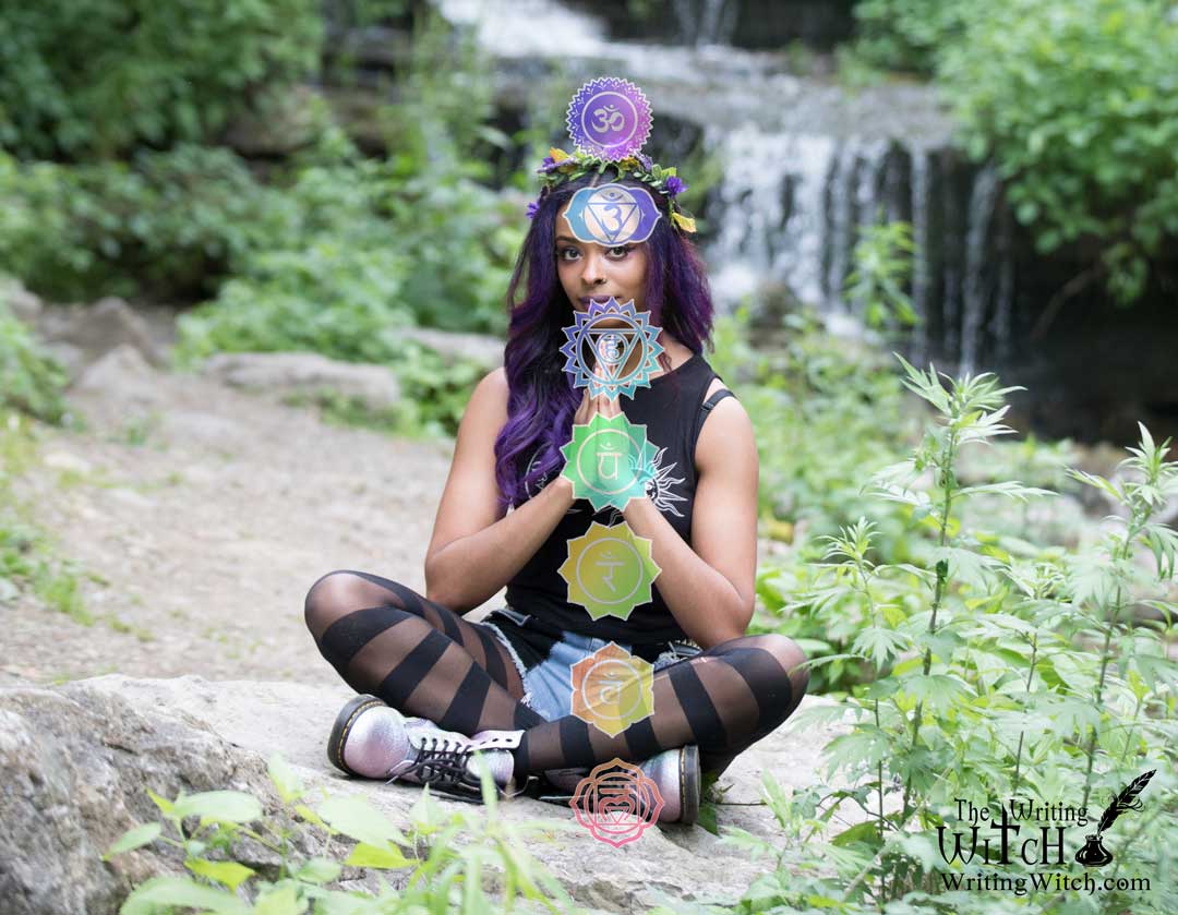woman meditating with chakra symbols