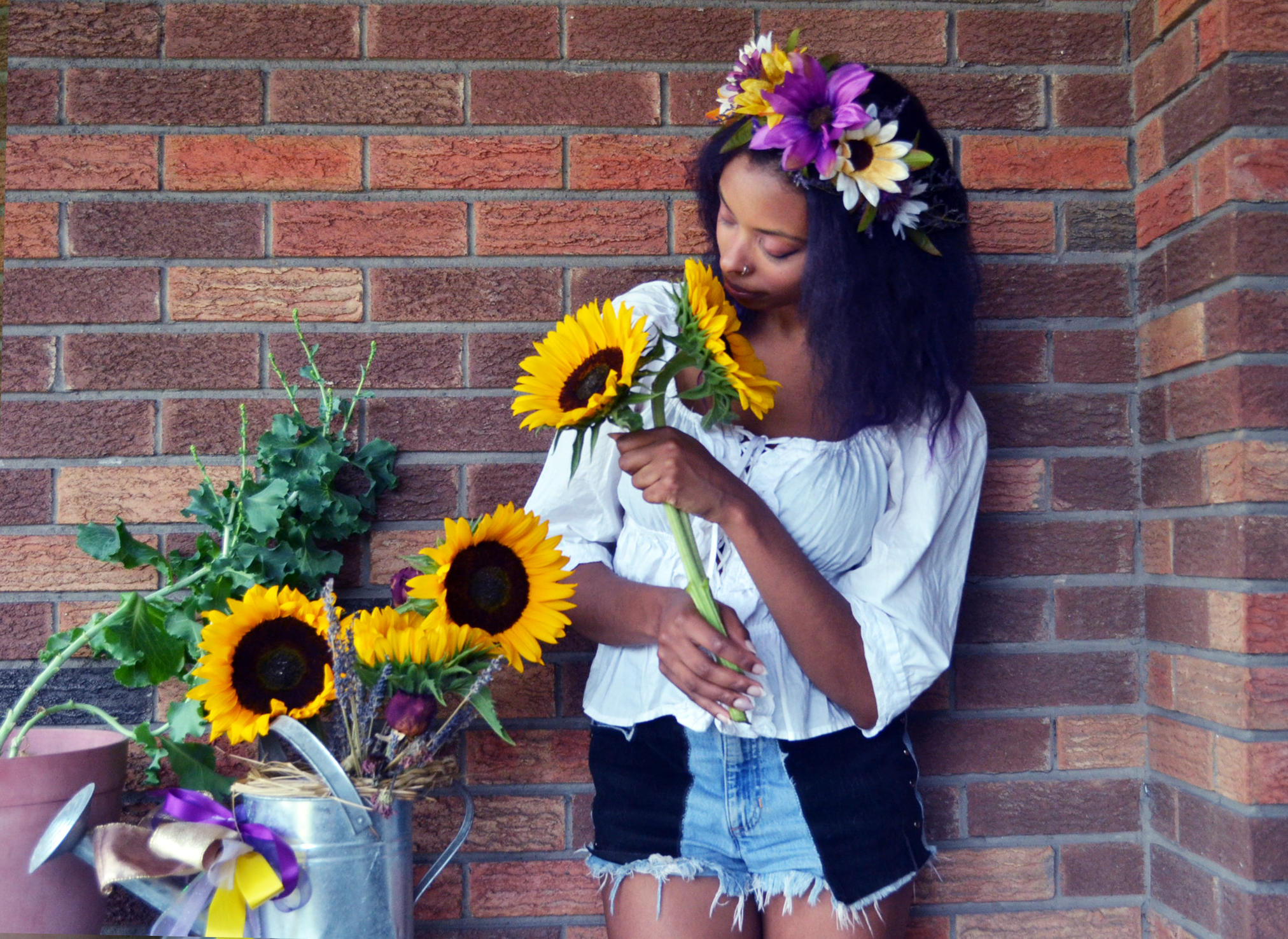 Woman with flower crown and sunflowers.