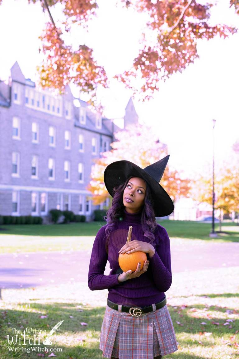 Afura outdoors with autumn witch hat and pumpkin