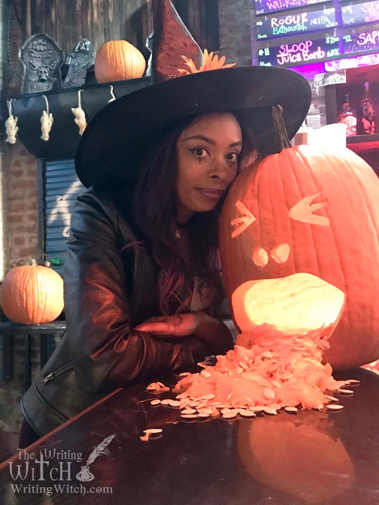 woman in a witch costume with a jack o lantern